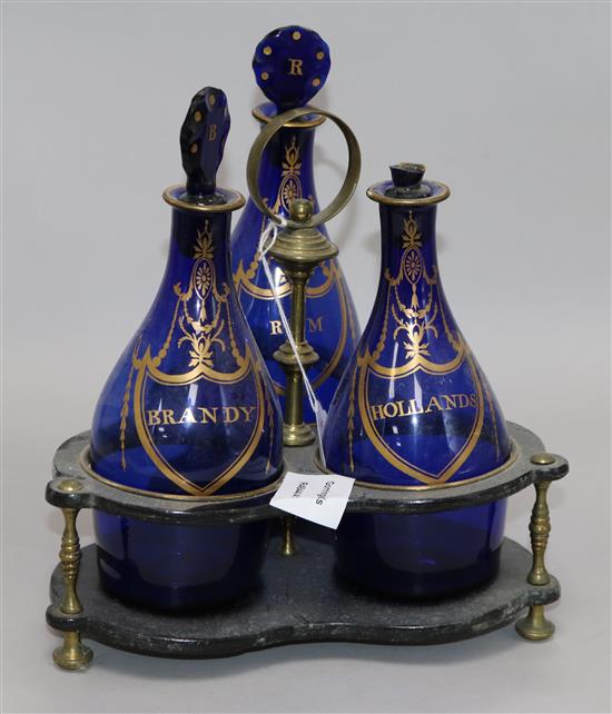 A set of three Regency Bristol blue glass decanters in a papier mache stand	